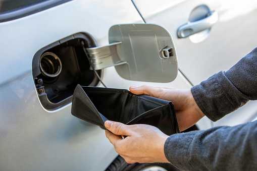 empty wallet by car's gas tank