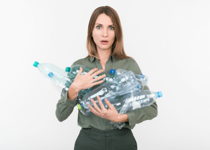 woman holding plastic water bottles